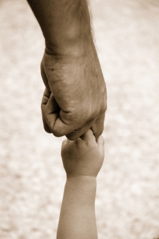 Father holding child's hand