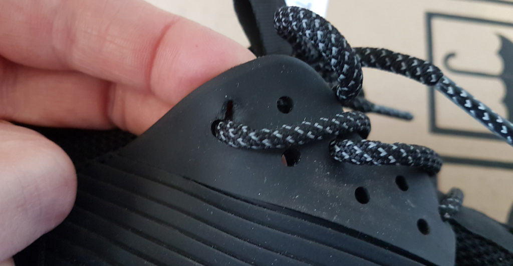 Close up of tear starting in the black Loom Footwear waterproof sneakers. 
