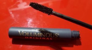 A tube of L'Oreal Voluminous Mascara open and showing brush.