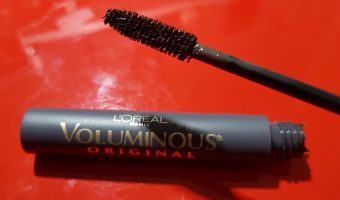 A tube of L'Oreal Voluminous Mascara open and showing brush.